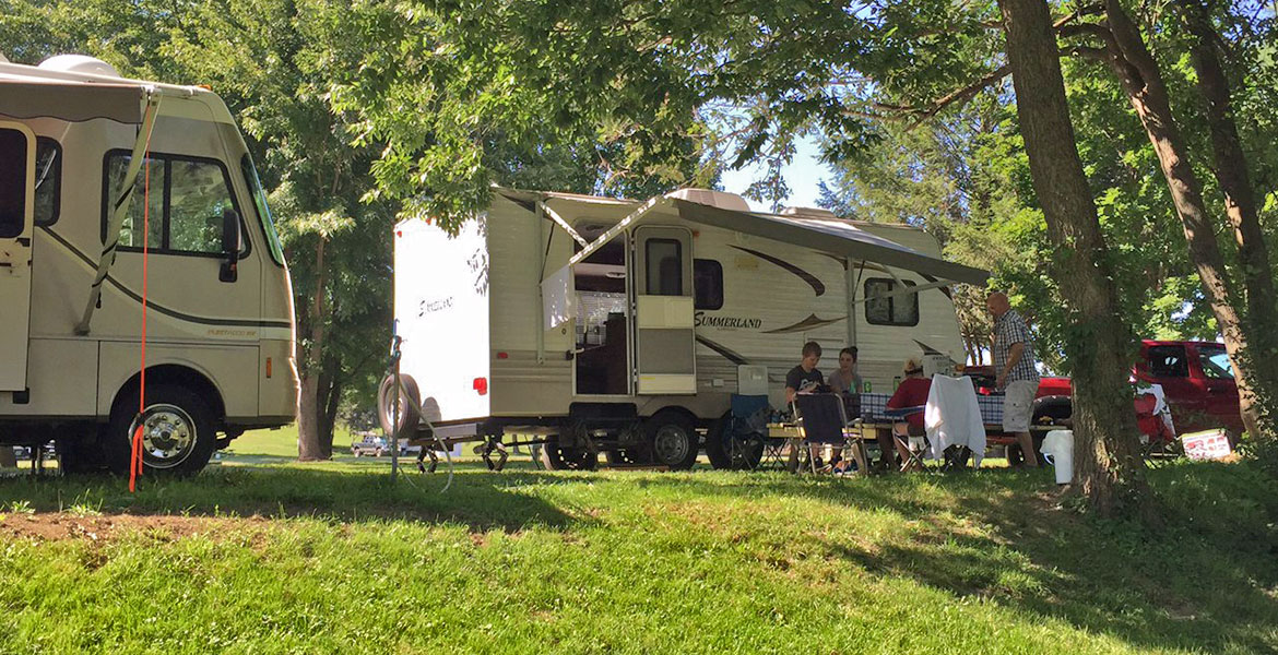 RV Site with Family sitting outside
